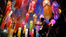 A shopkeeper arranges lanterns kept for sale ahead of the