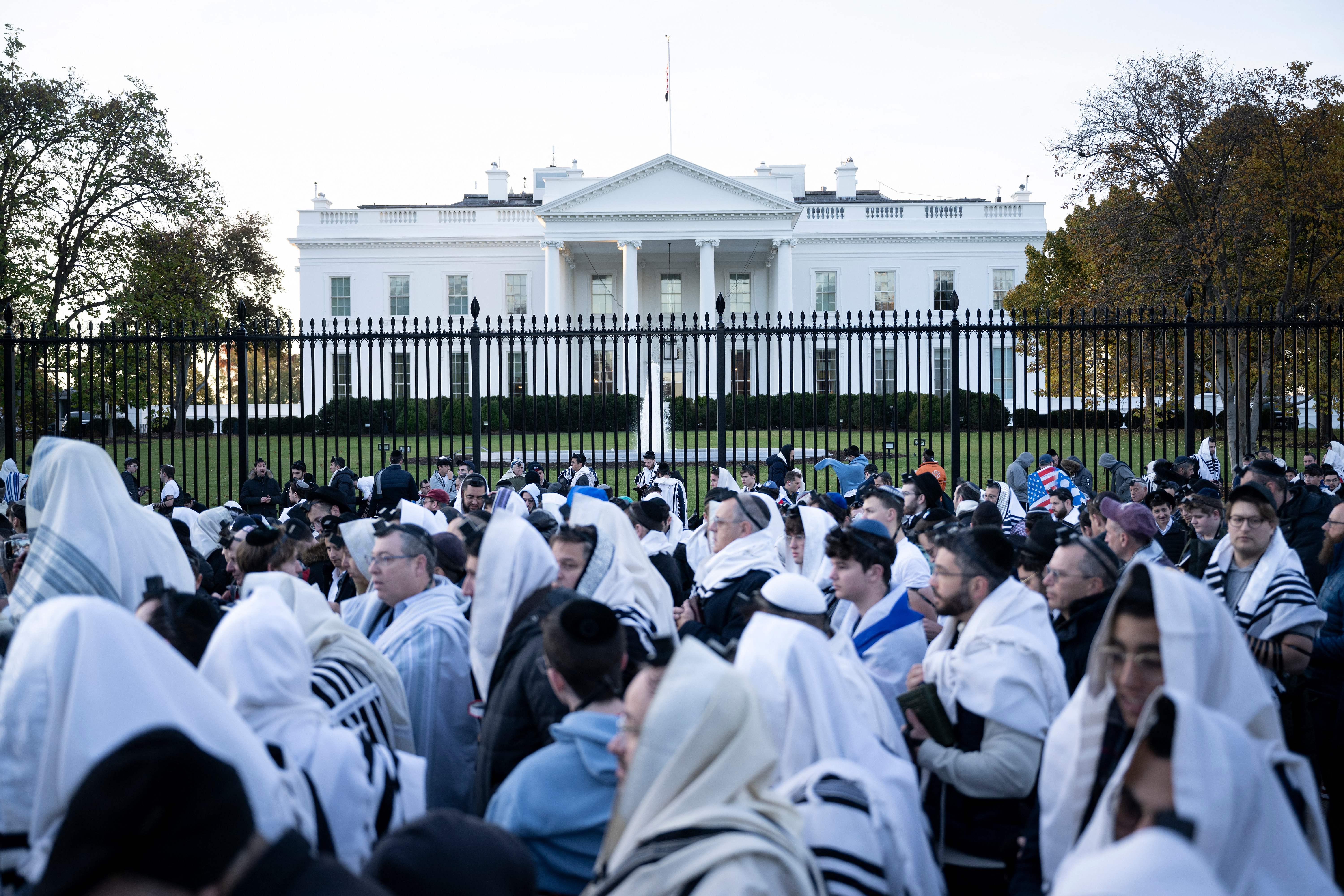 People pray on Pennsylvania Avenue in front of the White House before a rally supporting Israel during its conflict with Hamas, November 14, 2023 in Washington, DC.