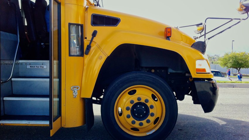 The front of a yellow school bus with the doors open.