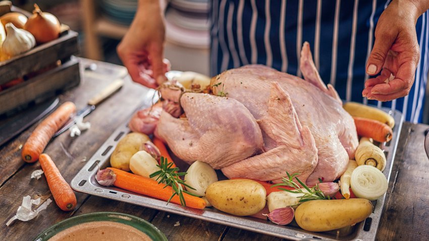 Preparing stuffed turkey with vegetables and other ingredients for holidays