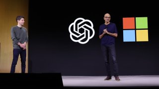 Microsoft CEO Satya Nadella (R) speaks as OpenAI CEO Sam Altman (L) looks on during the OpenAI DevDay event on November 06, 2023 in San Francisco, California. Altman delivered the keynote address at the first ever Open AI DevDay conference.