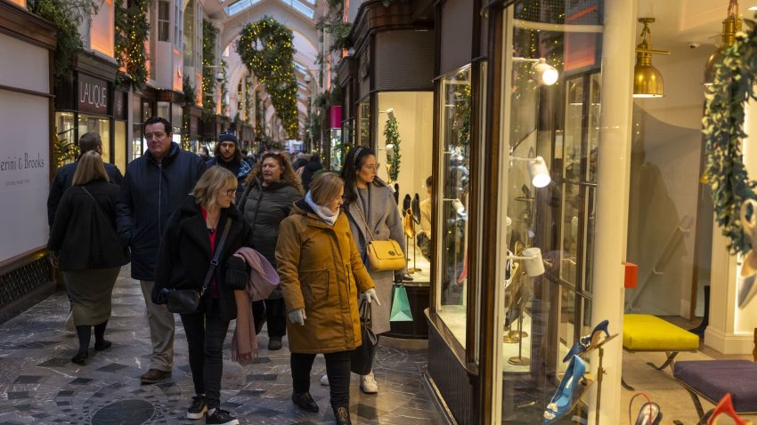 Pedestrians walk through the festively decorated Burlington Arcade luxury shopping arcade in London, UK, on Monday, Dec. 4, 2023. Inflation in UK shops has fallen to a 17-month low as retailers fight to attract shoppers ahead of the crucial holiday period. Photographer: Jason Alden/Bloomberg via Getty Images