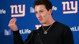 New York Giants quarterback Tommy DeVito talks to reporters