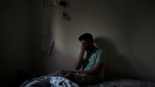 Eyal Barad pauses in the safe room where he sheltered with his family on Oct. 7 as Hamas militants killed and captured a quarter of the community on Kibbutz Nir Oz, Thursday, Nov. 9, 2023