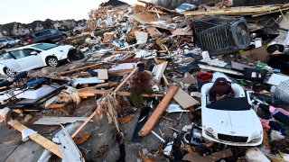 Debris covers the area around homes destroyed in the West Creek Farms neighborhood