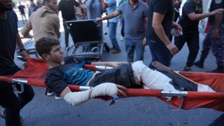 A Palestinian wounded in Israeli bombardment is brought to a hospital in Deir al-Balah, south of the Gaza Strip, Oct. 17, 2023.