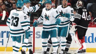 NEWARK, NEW JERSEY – DECEMBER 01: Jacob MacDonald #9 of the San Jose Sharks is congratulated by teammates Calen Addison #33 and Justin Bailey #90 during the second period against the New Jersey Devils at Prudential Center on December 01, 2023 in Newark, New Jersey. (Photo by Elsa/Getty Images)