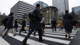 Morning commuters in front of the Bank of Japan headquarters in Tokyo, Japan, on Jan. 16, 2023.