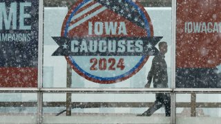 Heavy snow falls as a man walks along the Skywalk system that connects buildings in downtown on January 08, 2024 in Des Moines, Iowa. 