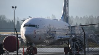 Alaska Airlines N704AL, a 737 Max 9, which made an emergency landing at Portland International Airport on January 5 is parked at a maintenance hanger in Portland, Oregon on January 23, 2024. 