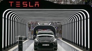 FILE – Model Y electric vehicles stand on a conveyor belt at the opening of the Tesla factory in Berlin Brandenburg in Gruenheide, Germany, Tuesday, March 22, 2022. Tesla production stands still because of The armed conflicts in the Red Sea and the associated shifts in transport routes between Europe and Asia.