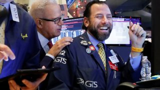 Traders work on the floor at the New York Stock Exchange.