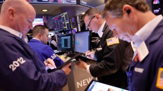 Traders work on the floor of the New York Stock Exchange during morning trading on January 31, 2024 in New York City. 