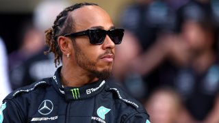 Lewis Hamilton of Great Britain and Mercedes looks on at the Mercedes GP Team Photo during previews ahead of the F1 Grand Prix of Abu Dhabi at Yas Marina Circuit on November 23, 2023 in Abu Dhabi, United Arab Emirates.