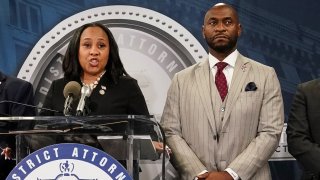 Fulton County District Attorney Fani Willis speaks at a press conference next to prosecutor Nathan Wade after a grand jury brought back indictments against former president Donald Trump and his allies in their attempt to overturn the state’s 2020 election results, in Atlanta on Aug. 14, 2023.