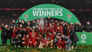 Liverpool players pose with the trophy