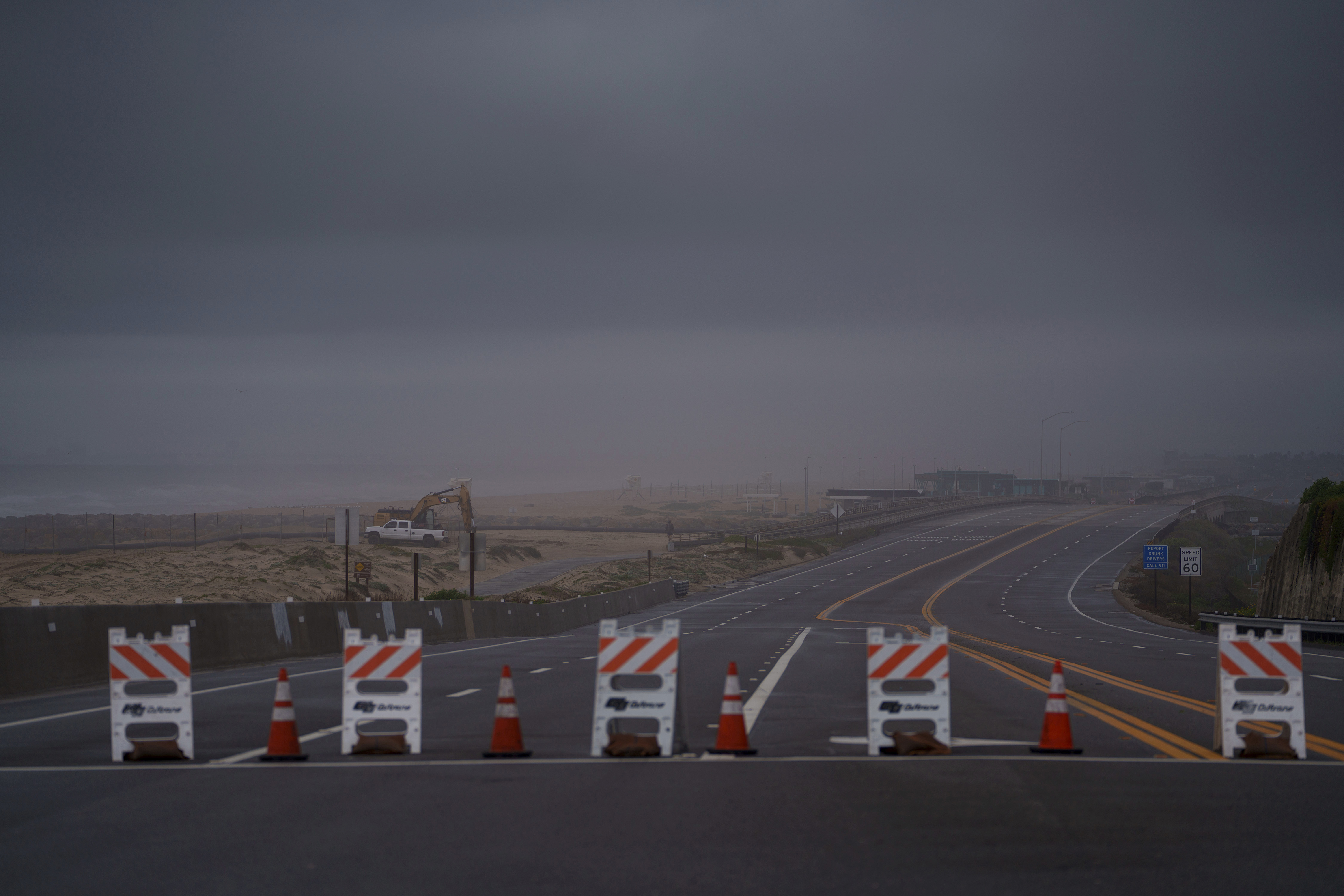 Barricades mark a closed Pacific Coast Highway due to flooding Thursday, Feb. 1, 2024 in Huntington Beach.