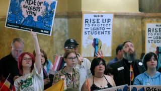 Kansas high school students, family members and advocates rally for transgender rights.