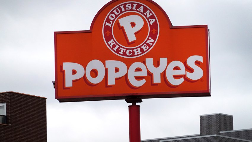 A sign hangs outside of a Popeyes Louisiana Kitchen restaurant on May 06, 2021 in Chicago, Illinois.  Chicken prices have risen sharply this year as suppliers struggle to keep up with demand, fueled in part, by the popularity of new chicken offerings from fast-food restaurants.