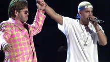 Elton John (L) joins rap musician Eminem (R) durin