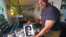 Kenneth Green Jr. looks at a picture of Black Panther founder Huey Newton taken by his late father, Kenneth Green, the first Black photographer at the Oakland Tribune. (Feb. 7, 2024)
