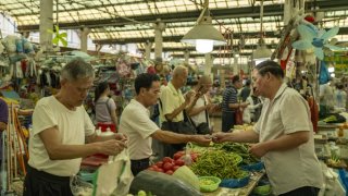 Customers at a fresh food market in Shanghai, China, on Monday, Aug. 7, 2023.