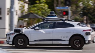 Passengers ride in an electric Waymo full self-driving technology in Santa Monica