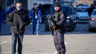 A police officer stands guard holding an anti-drone rifle in the outskirts of Moscow, Russia, Monday, March 25, 2024 near the Crocus City Hall, which was hit by a terrorist attack on Friday.