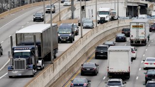 FILE – Motor vehicle traffic moves along the Interstate 76 highway in Philadelphia, March 31, 2021. T