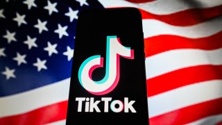In this photo illustration a TikTok logo is displayed on a