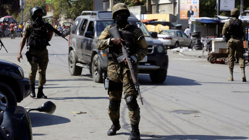 Members of the General Security Unit of the National Palace, USGPN, set up a security perimeter around one of the three downtown stations after police fought off an attack by gangs the day before, in Port-au-Prince, Haiti, Saturday, March 9, 2024.