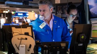 Traders work on the floor of the New York Stock Exchange (NYSE) on April 10, 2024 in New York City. As new inflation data released today showed a continued rise, stocks fell across the board with the Dow falling over 400 points.