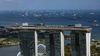 Container ships and bulk carriers behind the Marina Bay Sands hotel and casino offshore from Singapore, on Monday, Feb. 19, 2024.
