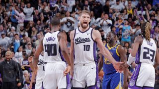 SACRAMENTO, CA – APRIL 16: Domantas Sabonis #10 high fives Harrison Barnes #40 and Keon Ellis #23 of the Sacramento Kings during the game against the Golden State Warriors during the 2024 Play-In Tournament on April 16, 2024 at Golden 1 Center in Sacramento, California. NOTE TO USER: User expressly acknowledges and agrees that, by downloading and or using this Photograph, user is consenting to the terms and conditions of the Getty Images License Agreement. Mandatory Copyright Notice: Copyright 2024 NBAE (Photo by Rocky Widner/NBAE via Getty Images)