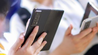Honor already has a number of smartphones on the market that fold like a book, such as the Magic V2 that was launched in July 2023 shown here. The Chinese tech company is now preparing to launch a vertical-folding style smartphone, its CEO George Zhao told CNBC at the Mobile World Congress.
