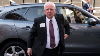 Attorney John Eastman, the architect of a legal strategy aimed at keeping former President Donald Trump in power, gets out of an SUV to talk to reporters after a hearing in Los Angeles, Tuesday, June 20, 2023.