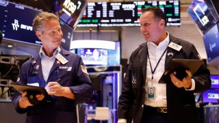 Traders work on the floor of the New York Stock Exchange during morning trading on April 29, 2024.