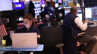 Traders work on the floor of the New York Stock exchange during morning trading on May 17, 2024.