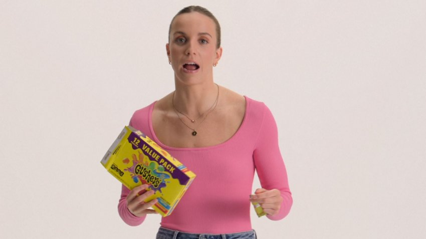 Regan Smith holds a box of gushers fruit snacks