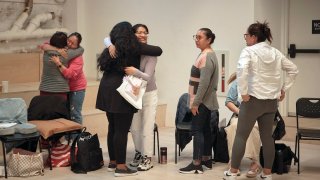 Attendees cry and hug during a sexual harassment prevention class for nannies and housekeepers on Saturday, April 27, 2024, in the Brooklyn borough of New York. Nannies, housekeepers, and home care workers are excluded from many federal workplace protections in the United States, and the private, home-based nature of the work means abuse tends to happen behind closed doors.