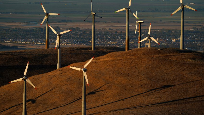 FILE - Wind turbines work in Livermore, Calif., Aug. 10, 2022. Federal energy regulators on Monday, May 13, 2024, approved a long-awaited rule to expand the amount of renewable energy such as wind and solar power that is transmitted to the electric grid, a key part of President Joe Biden’s goal to decarbonize the economy by 2050.