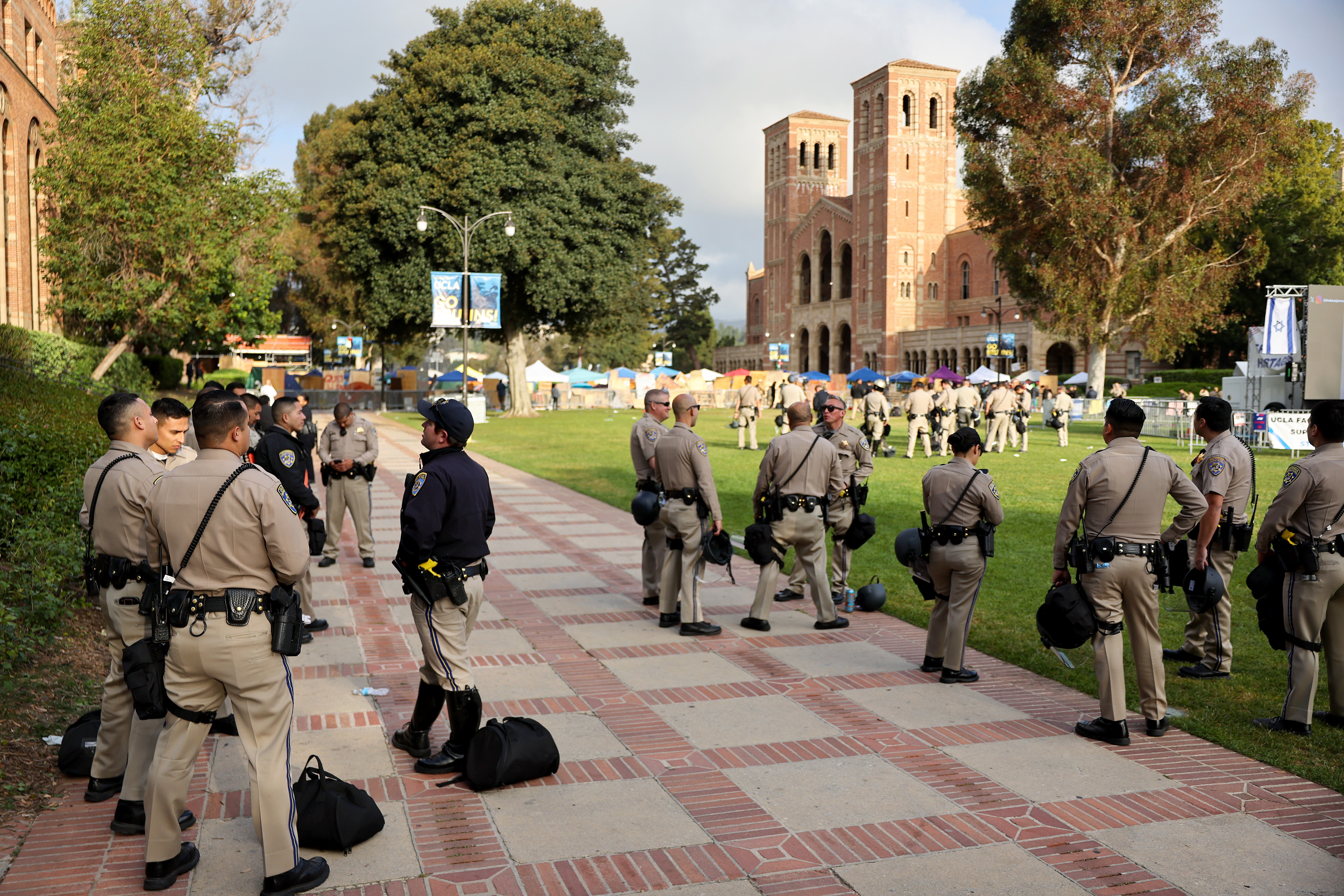 LOS ANGELES, CALIFORNIA – MAY 01: California Highway Patrol (CHP) officers keep watch at a pro-Palestinian encampment, the morning after it was attacked by counter-protestors at the University of California, Los Angeles (UCLA) campus, on May 1, 2024 in Los Angeles, California. A group of counter-protestors attacked the camp overnight leaving some demonstrators wounded. The camp was declared ‘unlawful’ by the university yesterday and classes have been cancelled today due to the violence. Pro-Palestinian encampments have sprung up at college campuses around the country with some protestors calling for schools to divest from Israeli interests amid the ongoing war in Gaza. (Photo by Mario Tama/Getty Images)