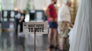 Voters check in to cast ballots on May 21, 2024, in Atlanta.