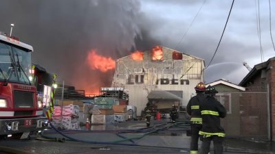 Four-alarm fire at Oakland lumber yard contained