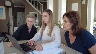 Stacey Hachenberg, left, and her partner, Sharon Fleming, right, review long-term care options with the help of Fleming’s daughter, Alexa Fleming, center.