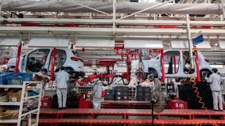 Employees work on the assembly line of new energy vehicles at a factory of Chinese EV startup Leapmotor on April 1, 2024 in Jinhua, Zhejiang Province of China.