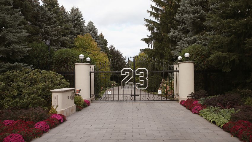 HIGHLAND PARK, IL – OCTOBER 21:  A gate with the number 23 controls access to the home of basketball legend Michael Jordan on October 21, 2013 in Highland Park, Illinois. Twenty-three is the number Jordan wore while playing basketball for the Chicago Bulls. The home which had been offered for sale for $29 million and later dropped to $21 million is scheduled to be sold at auction on November 22. The 32,683-squre-foot home features nine bedrooms, 19 bathrooms, a 15-car attached garage and an “NBA-quality” basketball court.   (Photo by Scott Olson/Getty Images)