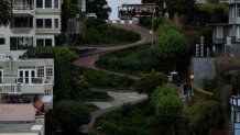 SAN FRANCISCO, CALIFORNIA - APRIL 23: In an aerial view, a cable car passes Lombard Street on April 23, 2024 in San Francisco, California. Ridership on San Francisco's famed cable cars has plummeted since the pandemic with only 58 percent of total ridership recovered from 2019. Cable cars were seeing an average of over 430,000 riders per month prior to the pandemic and now only have an estimated 295,000 rides per month. (Photo by Justin Sullivan/Getty Images)