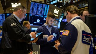 Traders work on the floor of the New York Stock Exchange on July 25, 2023.