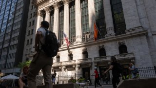People walk by the New York Stock Exchange (NYSE) on June 18, 2024 in New York City.